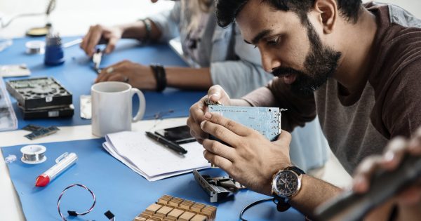 Electrical technicians working on electronics parts